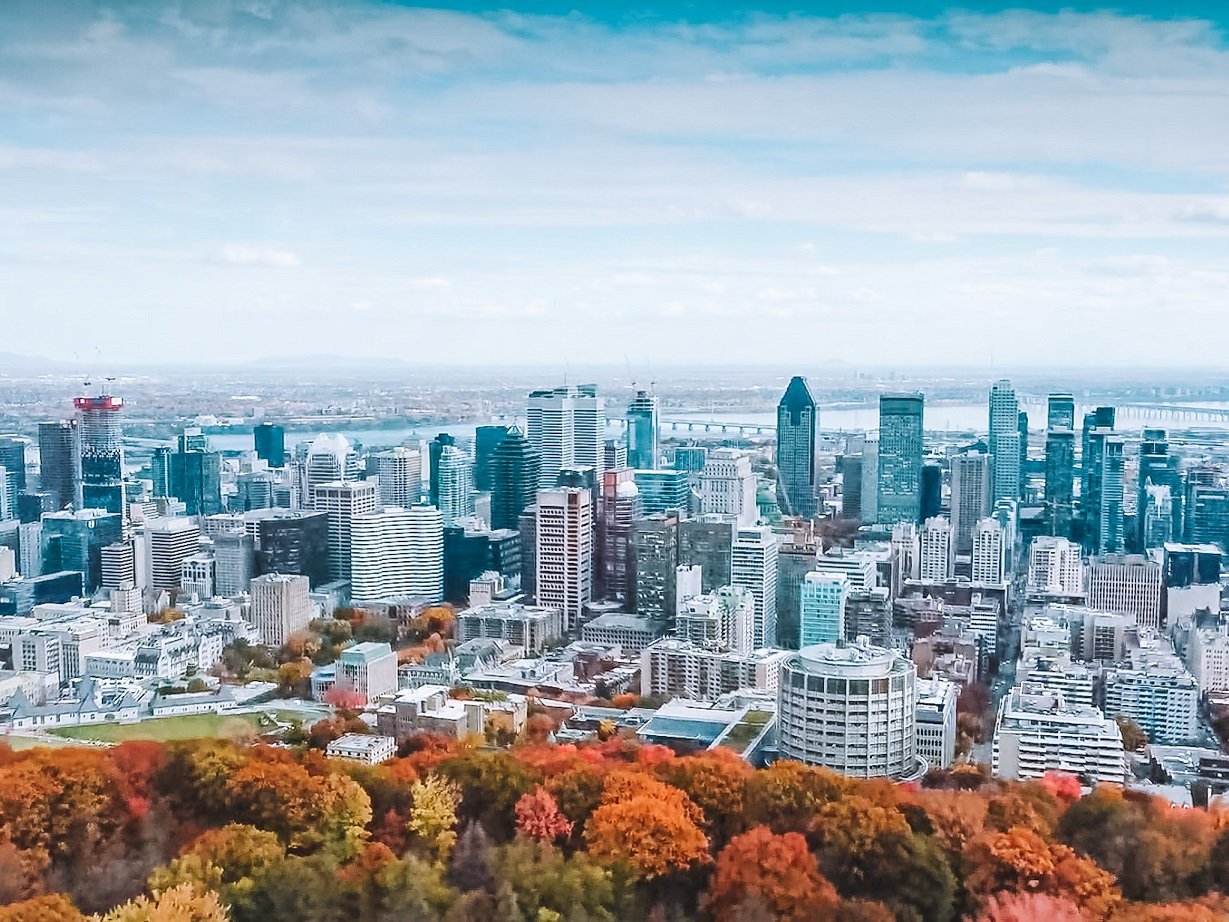 Best area to stay in montreal - drone shot skyline autumn - Pack and Jet blog